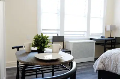 a room with a table and chairs and a bedroom at Newly Renovated - Minutes from the City in Woodside