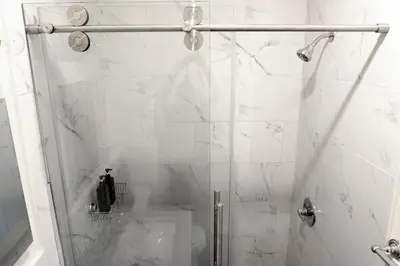 a bathroom with a shower with a glass door at Newly Renovated - Minutes from the City in Woodside