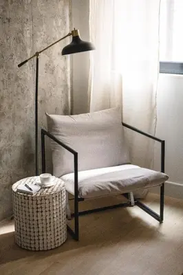 a chair sitting next to a lamp in a room at Luxury Full Floor Chelsea with WasherDryer 2bd in New York