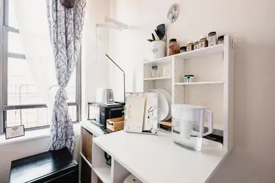a kitchen with a white counter and a window at Cat Room by Delicate Stays LIVING ROOM CONVERSION SHARED SPACE ROOM ONLY CAT FRIENDLY ONLY 25 min to time square in Jackson Heights