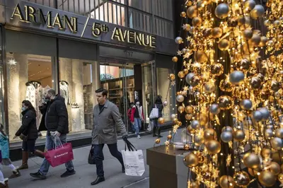 people walking down a street in front of a store at New York Suite Upper East Side Manhattan in New York