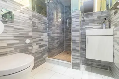 a bathroom with a toilet and a shower at New York Suite Upper East Side Manhattan in New York