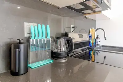 a kitchen counter with a coffee maker on a counter top at New York Suite Upper East Side Manhattan in New York