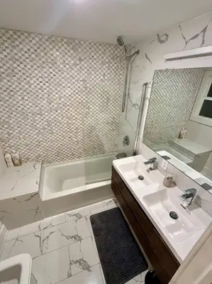 a bathroom with a sink and a tub and a mirror at Modern & Spacious 3 BED & 2 BA Condo mins from NYC in Jersey City