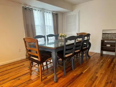 a dining room table and chairs in a room at Harmony in the Heights - Master in Newark