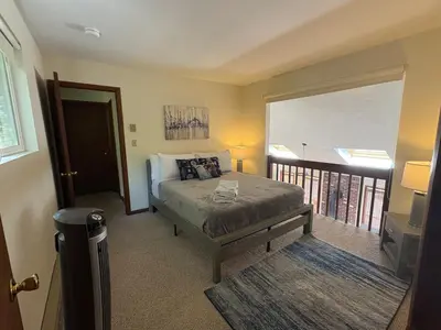 a bedroom with a bed and a balcony at Ash Cottage in Poconos near Camelback & Kalahari in Long Pond
