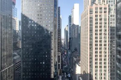 a view of a busy city street with tall buildings at Midtown West 1br w gym wd nr bryant park NYC-1380 in New York