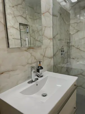 a white bathroom with a sink and a shower at Beautiful Apartment shared with the Host in the Heart of Bushwick in Brooklyn