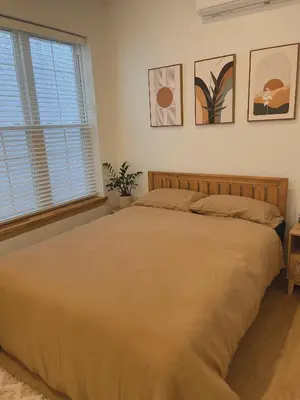 a bedroom with a large bed and a window at Beautiful Apartment shared with the Host in the Heart of Bushwick in Brooklyn
