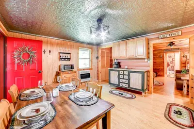 a kitchen and dining room with a table and chairs at Cardinal Pines Cabin on 8 Acres - Dog Friendly! in New Berlin