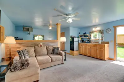 a living room with a couch and a kitchen at Cozy Catskills Studio Rental with Mountain Views! in Stamford