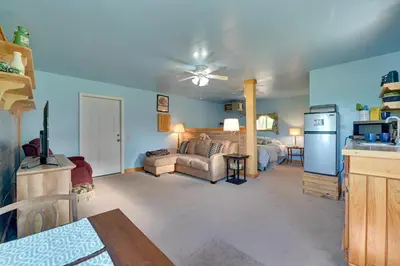a living room with a couch and a kitchen at Cozy Catskills Studio Rental with Mountain Views! in Stamford