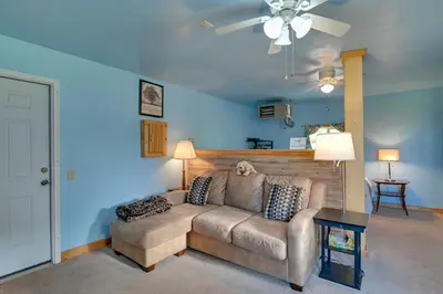 a living room with a couch and a ceiling fan at Cozy Catskills Studio Rental with Mountain Views! in Stamford