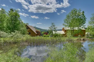 a farm with a pond and a barn at Catskills Cabin Rental with Hot Tub and Amazing Views! in Stamford