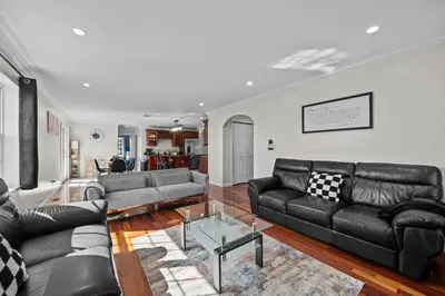a living room with black leather couches and a table at Spacious 6 BR Villa - Serene Scenic Mountain Escape in Bloomingburg