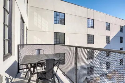a balcony with a table and a building at Dumbo 2br w wd roof gym nr TimeOut Building NYC-961 in Brooklyn