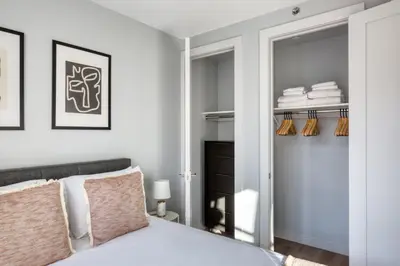 a bedroom with a bed and a closet at Dumbo 2br w wd roof gym nr TimeOut Building NYC-961 in Brooklyn