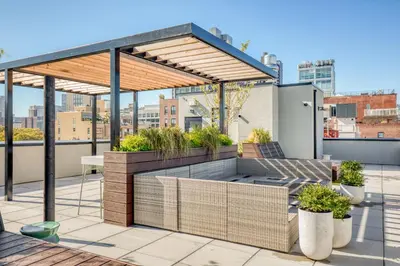 a rooftop patio with a pergola and plants at Dumbo 2br w wd roof gym nr TimeOut Building NYC-961 in Brooklyn