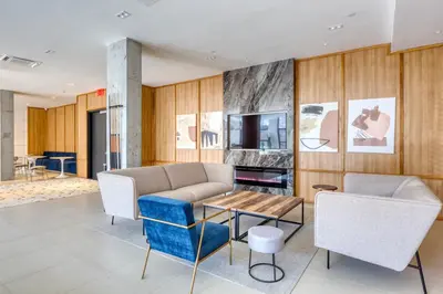 a living room with a couch and chairs and a table at Dumbo 2br w wd roof gym nr TimeOut Building NYC-961 in Brooklyn