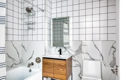 a bathroom with a sink and a mirror at Dumbo 2br w wd roof gym nr TimeOut Building NYC-961 in Brooklyn