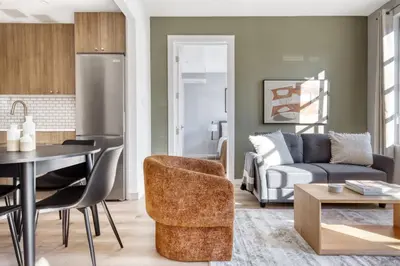 a kitchen and living room with a couch and a table at Dumbo 2br w wd roof gym nr TimeOut Building NYC-961 in Brooklyn