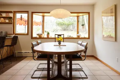 a dining room with a wooden table and chairs at Catskills Retro Retreat- Upstate Home W Hot Tub in Saugerties