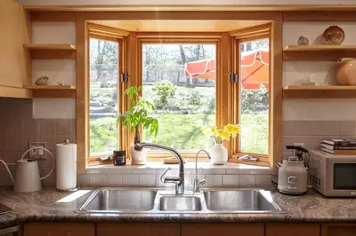 a kitchen counter with a sink and a window at Catskills Retro Retreat- Upstate Home W Hot Tub in Saugerties