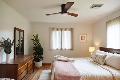 a bedroom with a bed and a ceiling fan at Catskills Retro Retreat- Upstate Home W Hot Tub in Saugerties