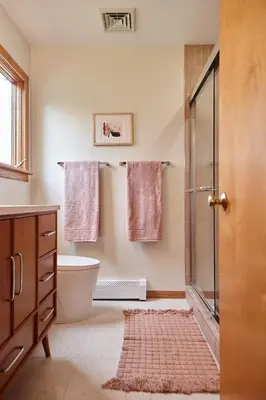 a bathroom with a shower and a toilet and towels at Catskills Retro Retreat- Upstate Home W Hot Tub in Saugerties