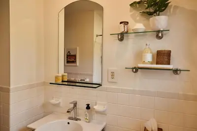 a bathroom with a sink and a mirror at Catskills Retro Retreat- Upstate Home W Hot Tub in Saugerties