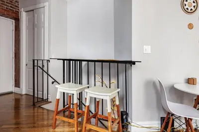 a room with two white stools and a table at Lovely Room at 3 bedroom Apt at the heart of East Village in New York