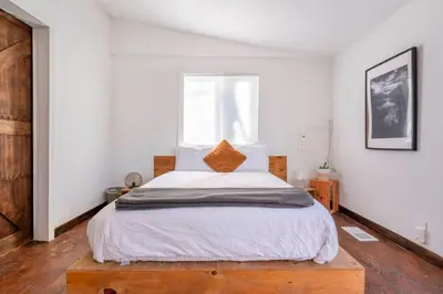 a bedroom with a large bed and a window at Serene Catskills Retreat with Deck in Woodbourne