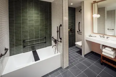 a bathroom with a tub and a shower and a sink at The Heartwood in Poughkeepsie