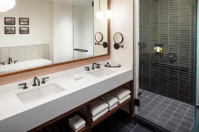 a bathroom with two sinks and a shower at The Heartwood in Poughkeepsie