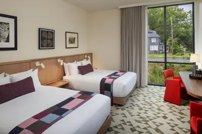 a hotel room with two beds and a window at The Heartwood in Poughkeepsie