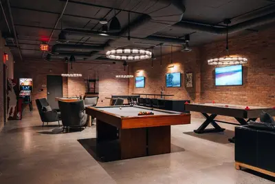 a room with a pool table and ping pong tables at Hyatus Luxury Residences Stamford in Stamford