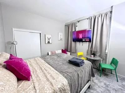 a bedroom with a large bed with pink pillows at Cozy apt in heart Manhattan #20 in New York