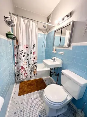 a blue bathroom with a toilet and a sink at Cozy apt in heart Manhattan #20 in New York