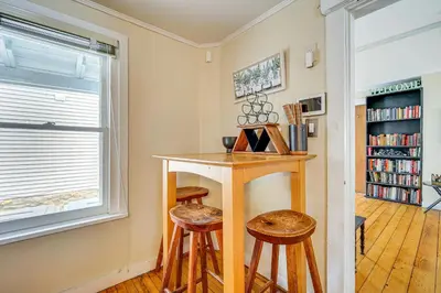 a small room with a table and two stools at Bennington Gem with Smart TV Near Historic District! in Bennington