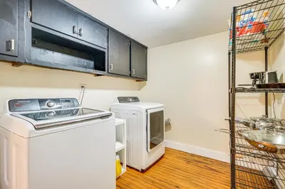 a small kitchen with a stove and a microwave at Bennington Gem with Smart TV Near Historic District! in Bennington