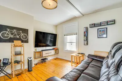 a living room with a couch and a flat screen tv at Bennington Gem with Smart TV Near Historic District! in Bennington