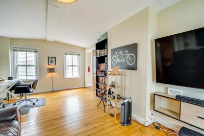 a living room with a large flat screen tv at Bennington Gem with Smart TV Near Historic District! in Bennington