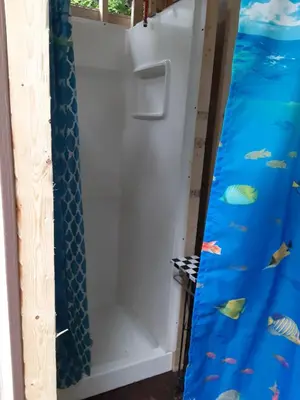 a door in a room with fish painted on it at Riverfront Ritz campsite in Lake Luzerne