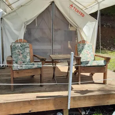 a table and two chairs in a tent at Riverfront Ritz campsite in Lake Luzerne