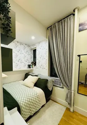 a bedroom with a bed and a window at Columbus House in New York