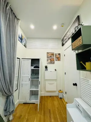 a room with white walls and wooden floors at Columbus House in New York