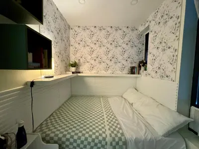 a small room with a bed with a checkered floor at Columbus House in New York