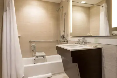 a bathroom with a sink and a tub and a shower at Holiday Inn Brooklyn Downtown by IHG in Brooklyn