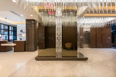 a lobby with a large chandelier in a building at Holiday Inn Brooklyn Downtown by IHG in Brooklyn
