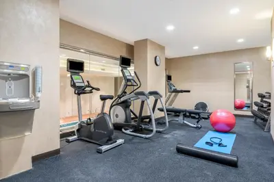 a gym with several exercise equipment in a room at Holiday Inn Brooklyn Downtown by IHG in Brooklyn